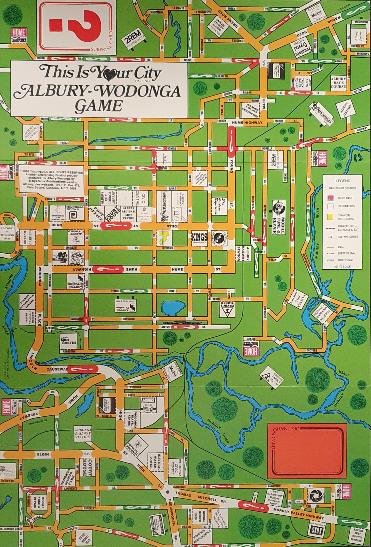 THIS IS YOUR CITY original game board. A street map of Albury and Wodonga from North Albury to High Street Wodonga, includes a box for destination cards and surprise cards, with the Murray River snaking across the game board as a divider of the two cities. It is brightly-coloured in green, orange and white and blue.